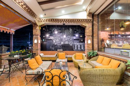 a lobby with couches and a table and chairs at Dahlia Boutique Hotel in Pokhara
