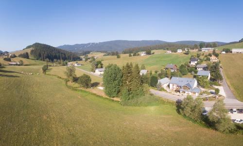 an aerial view of a small village in the hills at Arcanson in Méaudre