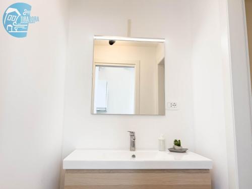a bathroom with a white sink and a mirror at Basovizza 3 Nicole Tirabora Short Rent in Villa Opicina