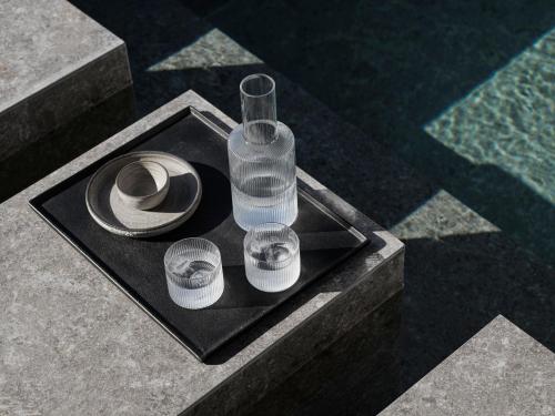 a table with glasses and a hat on it at Noima Boutique Hotel Mykonos in Agios Ioannis Mykonos