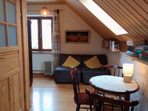 a living room with a couch and a table at Agroturystyka Millerówka in Kamionka Mała