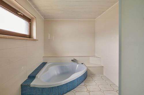 a bath tub in a bathroom with a window at Villa Bademeusel in Straupitz