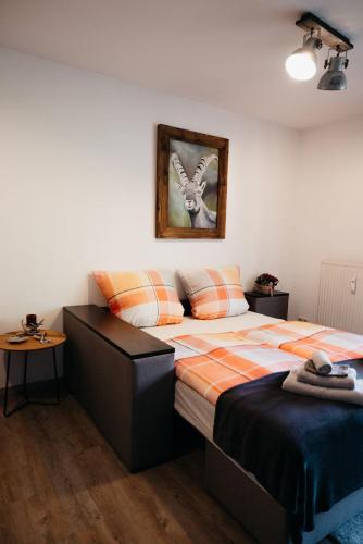 a bedroom with a bed and a picture on the wall at Ferienappartement Austen in Piding