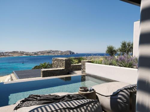 a swimming pool with a view of the ocean at Noima Boutique Hotel Mykonos in Agios Ioannis Mykonos