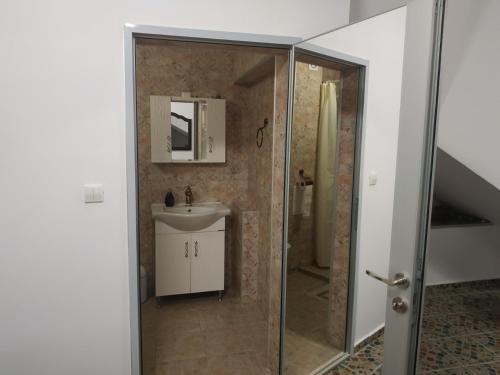 a bathroom with a shower and a sink at Къщата с разкопките in Sozopol