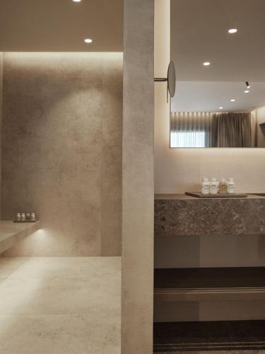 a bathroom with a sink and a mirror at Noima Boutique Hotel Mykonos in Agios Ioannis Mykonos