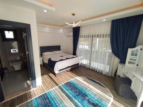 a bedroom with a bed and a window and a rug at Villa KayaHan Göcek in Göcek
