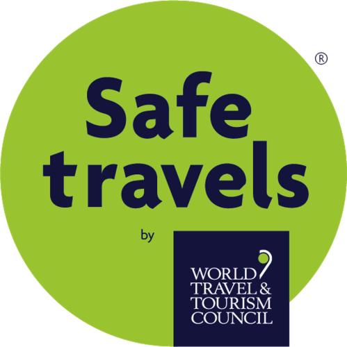 a sign with the words safe travels on a green circle at B Hotel Bishkek in Bishkek