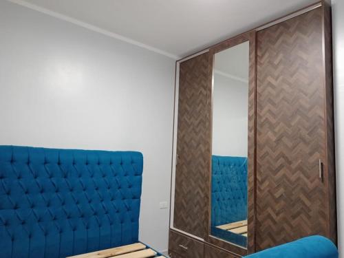 a room with a blue couch and a mirror at Alhambra 2 rooms Apartment in Hurghada