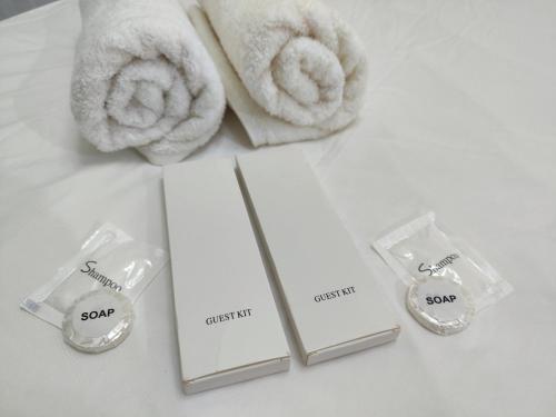 a group of towels and certificates on a table at White Nordic Fully-Furnished Studio at INSPIRIA in Davao City