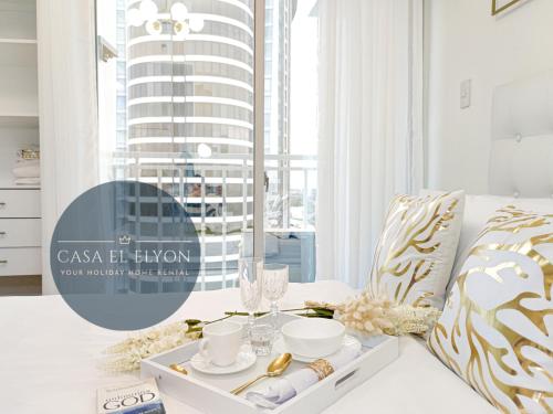 a white living room with a table with a serving tray at White Nordic Fully-Furnished Studio at INSPIRIA in Davao City