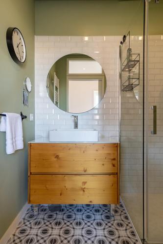 a bathroom with a sink and a mirror at Green House By Shi Studio in Leça da Palmeira