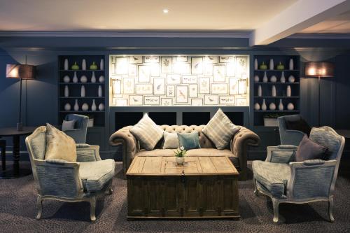 a living room with a couch and two chairs and a table at Sunday Box Hill Burford Bridge Hotel in Dorking