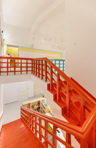 a staircase with wooden railings in a room at Locul Midtown-Indiranagar in Bengaluru
