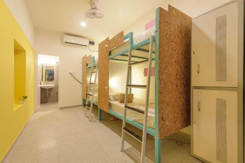 a corridor with bunk beds in a room at Locul Midtown-Indiranagar in Bengaluru