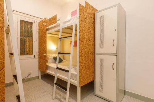 a room with two bunk beds and a mirror at Locul Midtown-Indiranagar in Bengaluru
