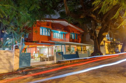 a building on a street at night with cars at Locul Midtown-Indiranagar in Bengaluru