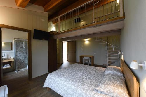 a bedroom with a bunk bed and a staircase at Casale dei Briganti in Norcia