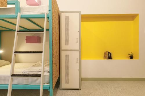 a room with bunk beds and a closet at Locul Midtown-Indiranagar in Bengaluru
