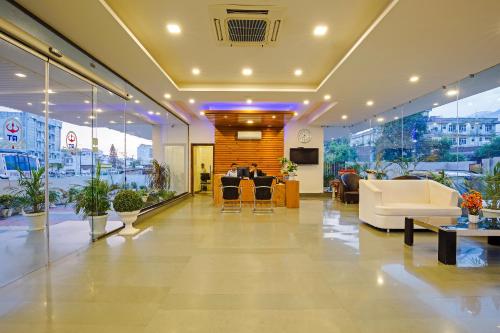 a lobby with white furniture in a building at Rama Trident, Katra in Katra