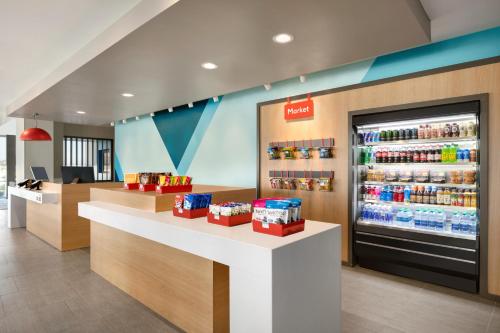 a store with a drink counter and a refrigerator at avid hotel - Tuscaloosa - University Area by IHG in Tuscaloosa