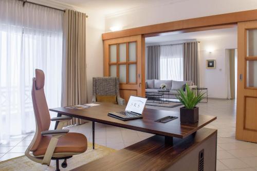 a desk with a laptop on it in a living room at Pier Harbour Residences and Spa in Lagos