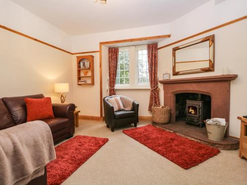a living room with a couch and a fireplace at The Lodge in Penrith
