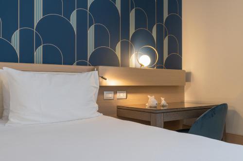Ένα ή περισσότερα κρεβάτια σε δωμάτιο στο Grand Hotel Alassio Beach & Spa Resort - The Leading Hotels of the World