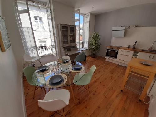 une cuisine avec une table et des chaises dans une pièce dans l'établissement Le TAYLOR Hypercentre, Spacieux & Lumineux, à Pau