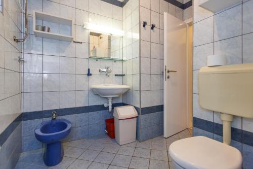 a bathroom with a toilet and a sink at Apartments Pika in Krk