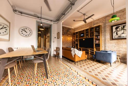 a living room with a table and a couch at Bravissimo Les Rajoles, Unique 3-bedroom apartment in Girona