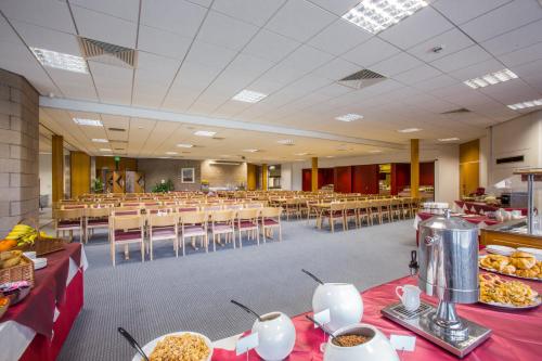 a cafeteria with tables and chairs with food on them at Agnes Blackadder Hall - Campus Accommodation in St. Andrews