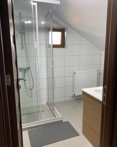 a bathroom with a shower and a sink at Vila San Nicoara in Curtea de Argeş