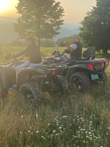two people are sitting on atvs in a field at Etno selo Milanovic - Nonac in Kuršumlija