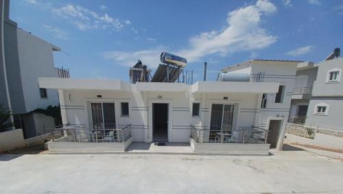 a white building with a sign on top of it at Villa Egli Ksamil in Ksamil