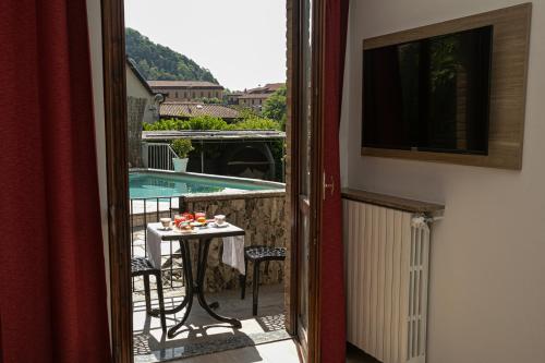 a view of a balcony with a table and a pool at Villa Cuore in Tavernerio