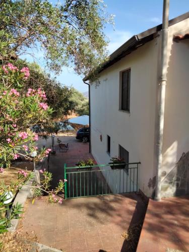 a house with a gate in front of a yard at L'Antica Quercia B&B in CastellʼUmberto