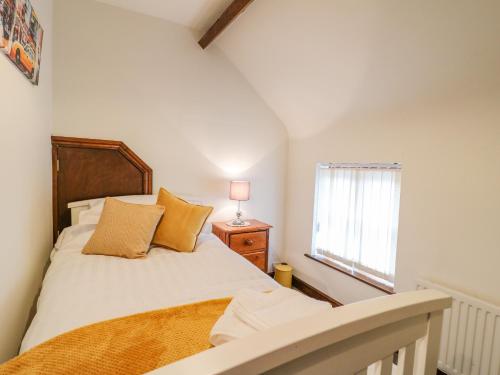 a bedroom with a bed and a window at The Cottage in Mapperley