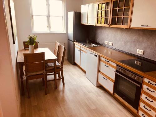 a kitchen with a table and a dining room at Urlaub auf Mittelhof in Großenbrode