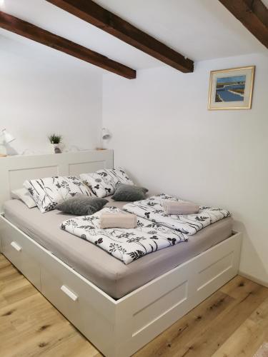 a bed in a room with white walls at Country house in Ankaran