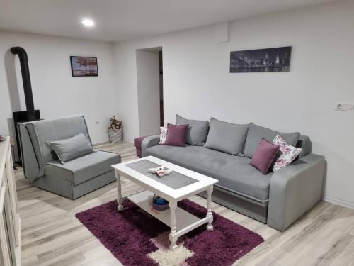 a living room with a couch and a table at Apartman Nermin in Mostar