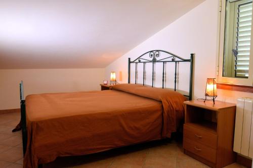 a bedroom with a bed with two lamps on it at Sovareto Mare in Sciacca