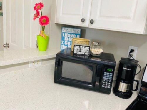 a microwave sitting on a counter in a kitchen at Mini Pearl, Private 2 BR - 1 block to BEACH! in Tybee Island