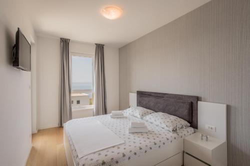 A bed or beds in a room at Luxury Apartment "Ema" with sea view & parking