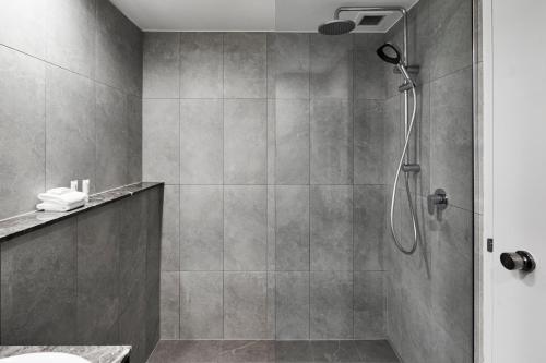 a bathroom with a shower with a shower head at Crowne Plaza Sydney Airport by IHG in Sydney