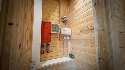 a bathroom with a wooden wall and a door at Sundance Lodge, Fantastic New Cabin with Hot Tub - Sleeps 6 - Largest In Felmoor Park in Morpeth
