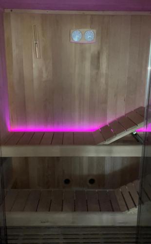 a wooden shelf with pink lights on top of it at Casale Torre San Magno in Corato