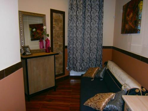 a living room with a couch and a mirror at Art Apartments in Poznań