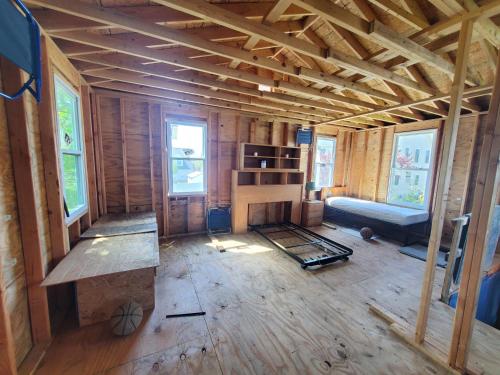 an unfinished room with a fireplace in a house at Room in Cabin - Camping Cabin With Sauna Access 2nd Fl- in Dover