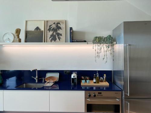 a kitchen with a sink and a refrigerator at 3-bedroom beach villa with a pool and private sauna in Green Coast Palase in Palasë